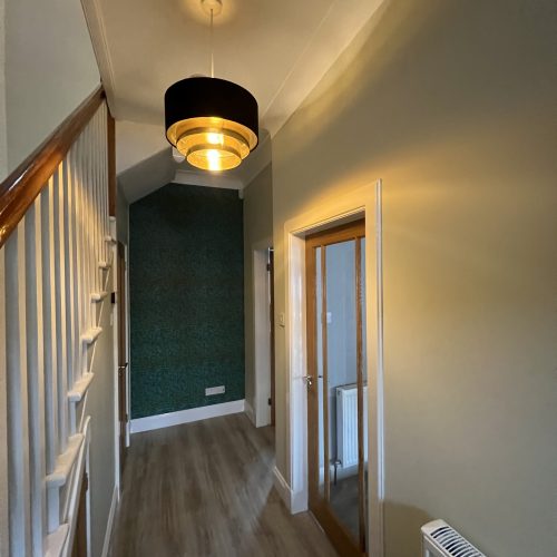 Home 4 Hallway and staircase decorated with white banister and teal feature wall, Ayr